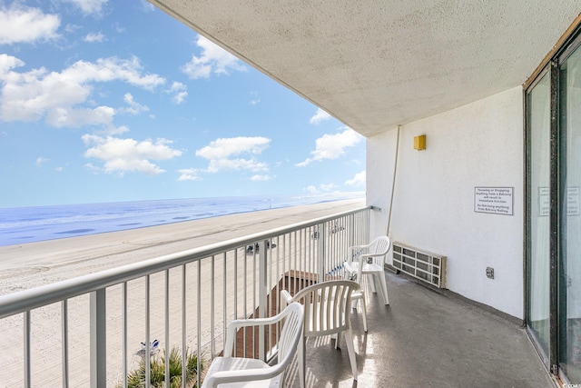 balcony with a view of the beach and a water view