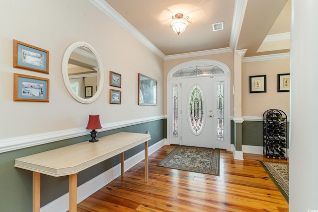 entryway featuring hardwood / wood-style floors and crown molding