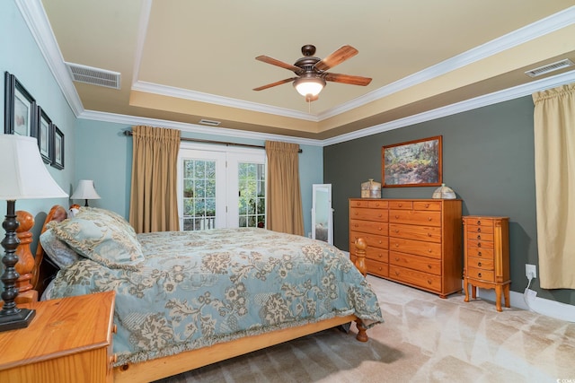 carpeted bedroom with a tray ceiling, access to outside, ornamental molding, and ceiling fan