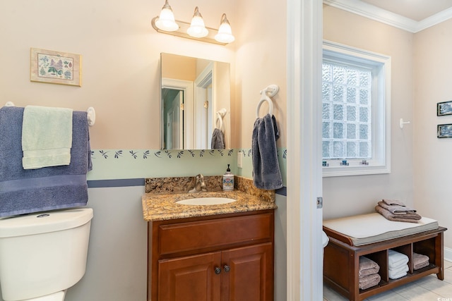 bathroom with crown molding, tile patterned floors, vanity, and toilet