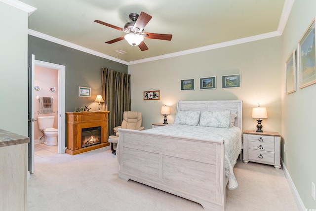 bedroom featuring ornamental molding, light carpet, ceiling fan, and ensuite bathroom