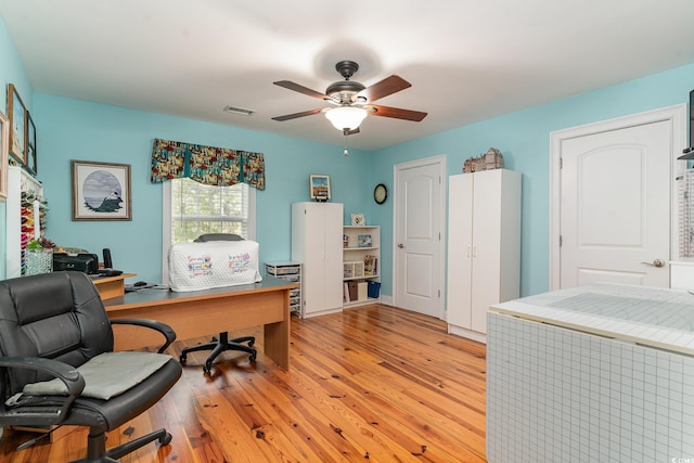 office space with light hardwood / wood-style flooring and ceiling fan