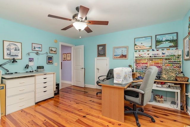 office with light hardwood / wood-style floors and ceiling fan