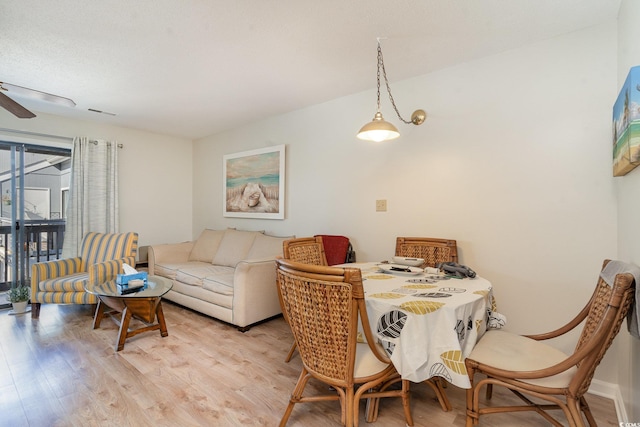 dining area with ceiling fan and light hardwood / wood-style flooring