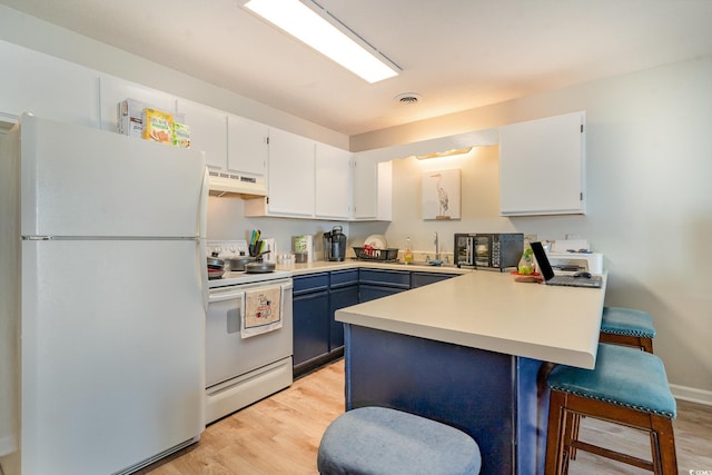 kitchen with a kitchen bar, blue cabinets, white cabinetry, kitchen peninsula, and white appliances