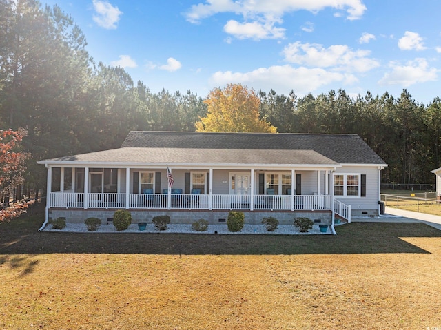 ranch-style house with a front yard and covered porch