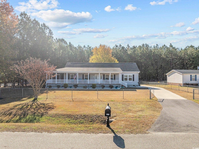 single story home with a front yard and covered porch