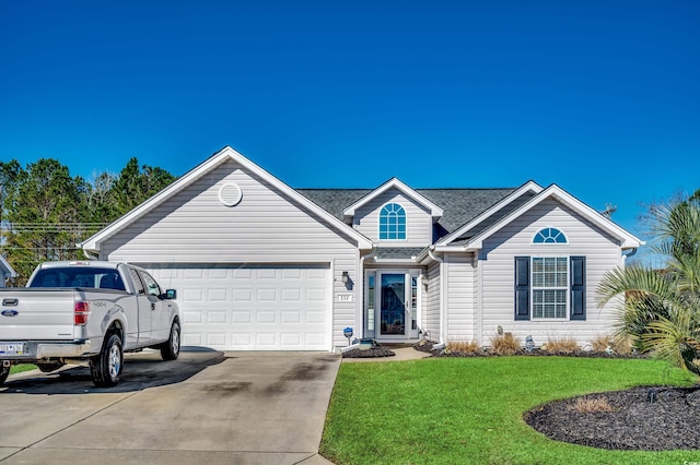 view of front of home featuring a garage and a front lawn