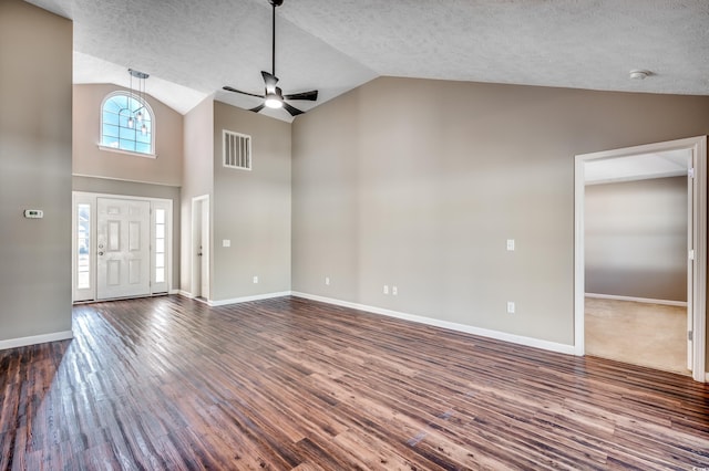 entrance foyer featuring ceiling fan, lofted ceiling, dark hardwood / wood-style flooring, and a wealth of natural light