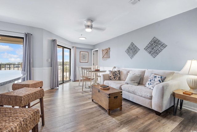 living room with ceiling fan and wood-type flooring