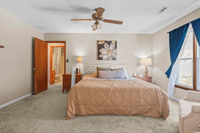 carpeted bedroom with ceiling fan and a textured ceiling