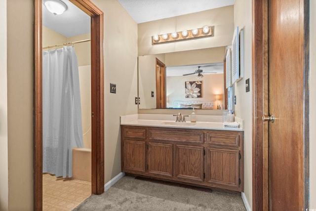 bathroom with walk in shower, ceiling fan, and vanity