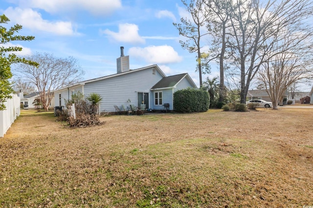 back of house featuring a lawn