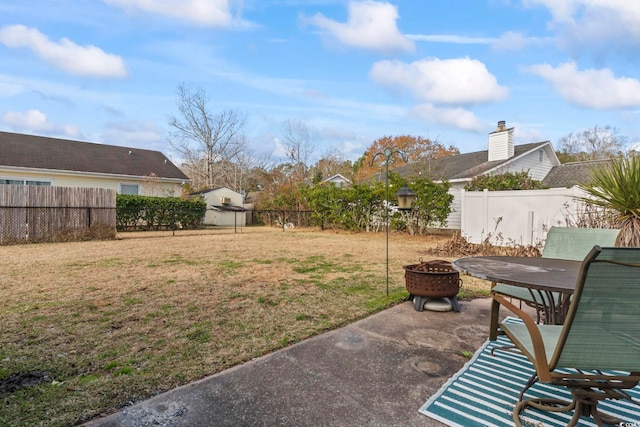 view of yard with a patio area and an outdoor fire pit