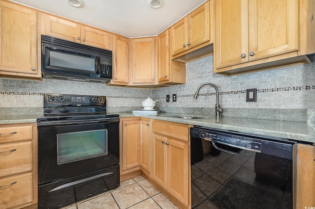 kitchen featuring light tile patterned floors, tasteful backsplash, light brown cabinetry, black appliances, and a sink