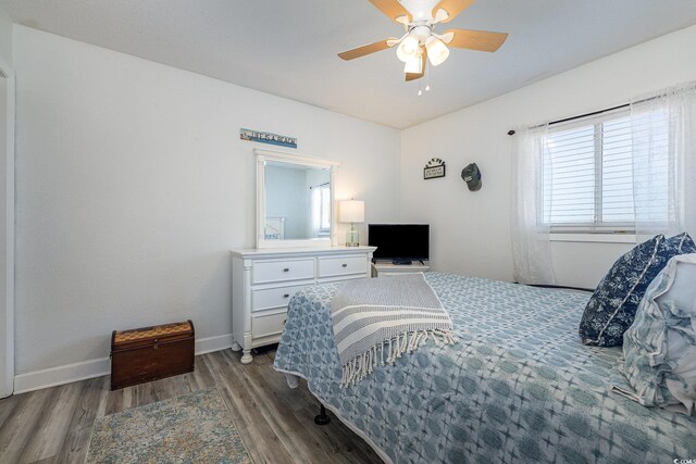 bedroom featuring dark hardwood / wood-style floors and ceiling fan