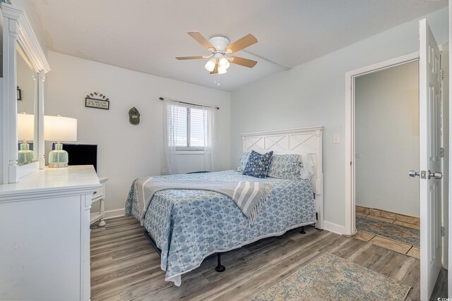 bedroom with hardwood / wood-style floors and ceiling fan