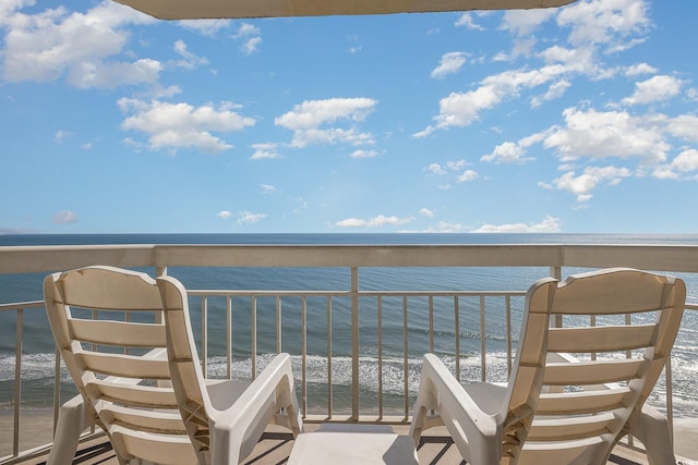 balcony with a water view and a beach view