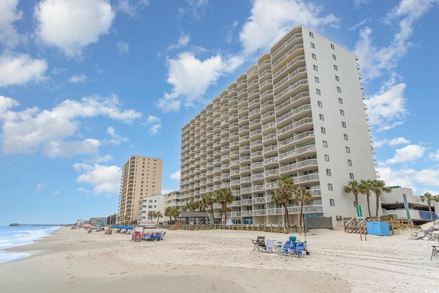 view of property featuring a water view and a view of the beach