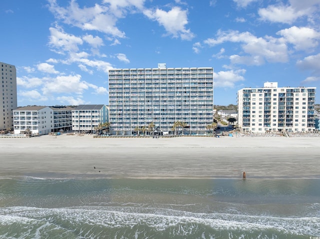 exterior space featuring a water view and a beach view