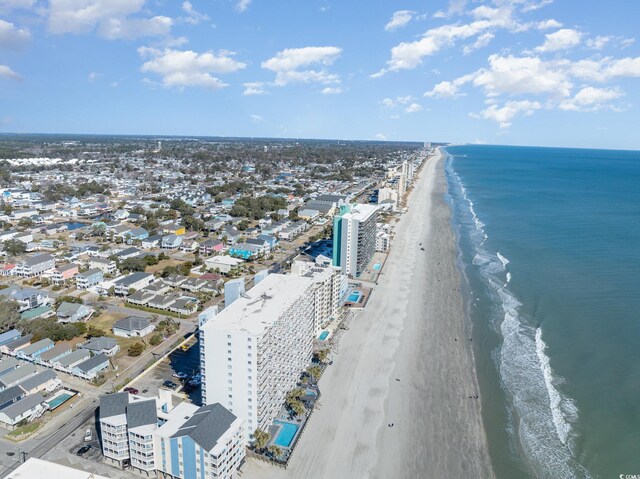 birds eye view of property with a beach view and a water view