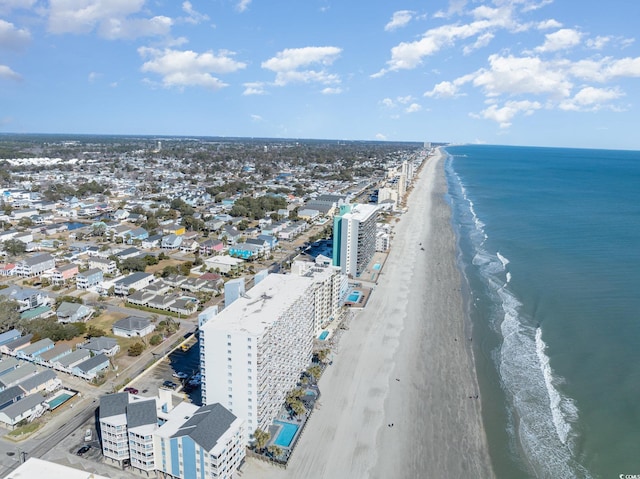 drone / aerial view featuring a water view and a view of the beach