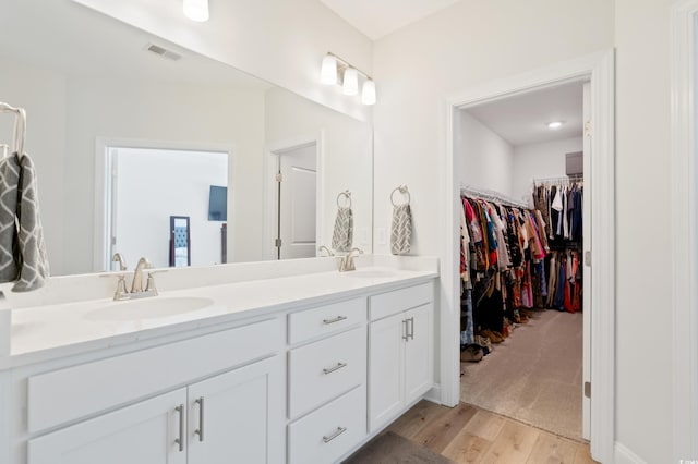 bathroom with vanity and wood-type flooring