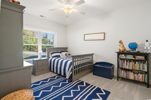 bedroom featuring light colored carpet and ceiling fan