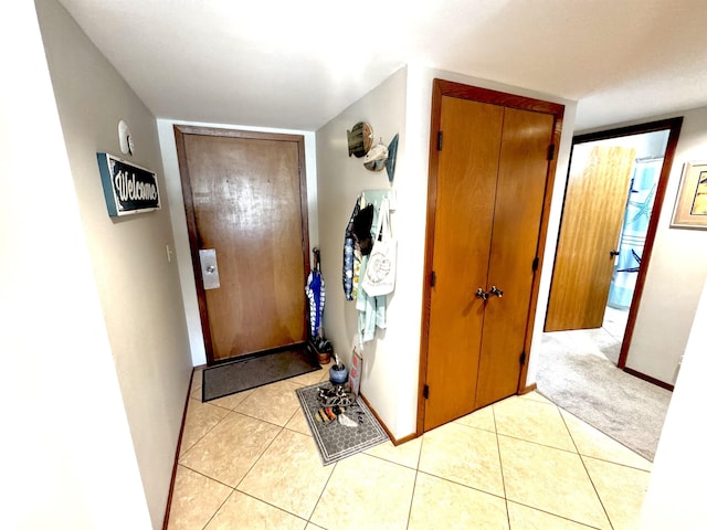 doorway with light tile patterned flooring