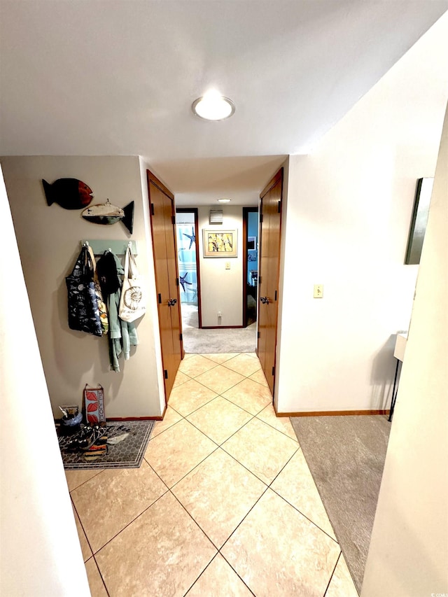 hallway featuring light tile patterned floors