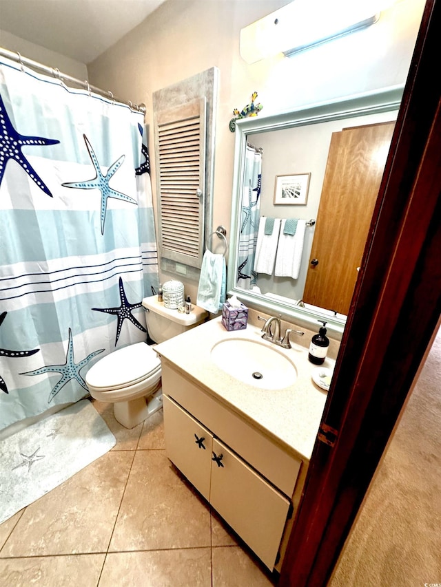 bathroom featuring vanity, toilet, and tile patterned flooring