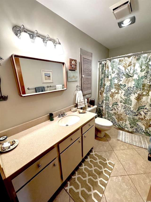 bathroom with vanity, tile patterned flooring, and toilet