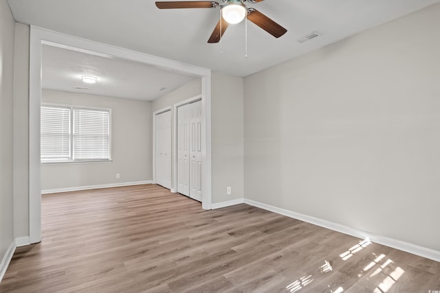 unfurnished bedroom with ceiling fan and light hardwood / wood-style flooring