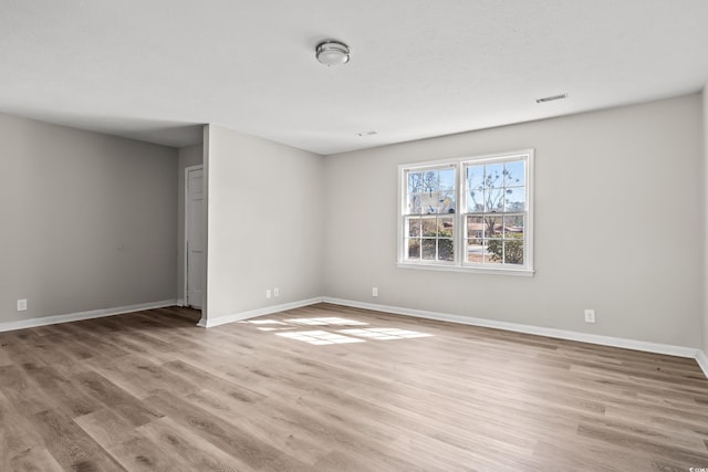 unfurnished room with light hardwood / wood-style flooring