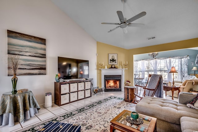 1579 Southwood Dr, Surfside Beach, SC 29575 - living room featuring ceiling fan, tile patterned floors, a lit fireplace, high vaulted ceiling, and baseboards