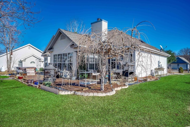 1579 Southwood Dr, Surfside Beach, SC 29575 - back of property with a chimney, a lawn, and a patio
