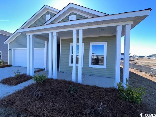 view of front facade with a porch and a garage