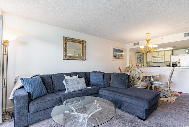 living room featuring an inviting chandelier, carpet floors, and a textured ceiling