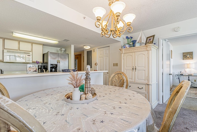 carpeted dining area with a textured ceiling and a notable chandelier