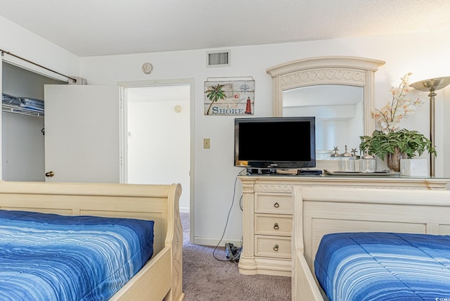 carpeted bedroom with a textured ceiling