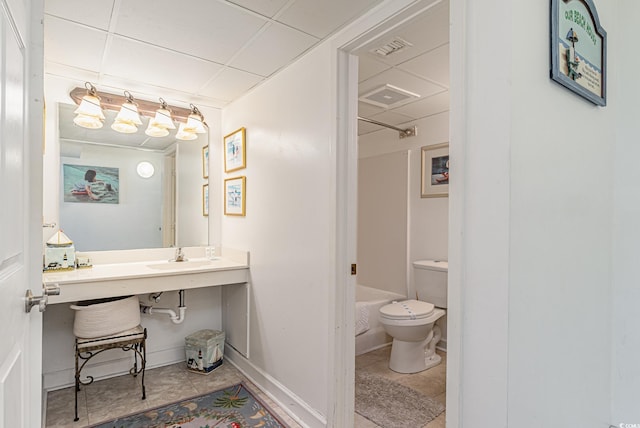 full bathroom with sink, a paneled ceiling, shower / tub combination, tile patterned floors, and toilet