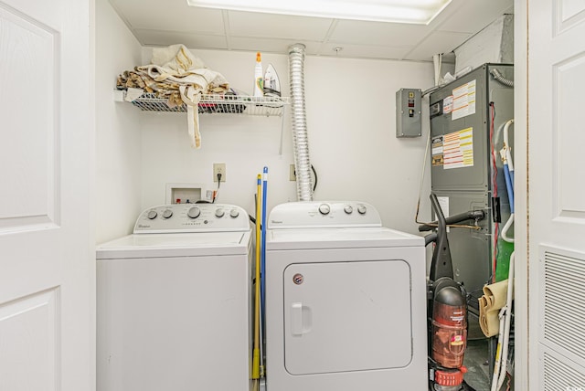 clothes washing area with washing machine and dryer