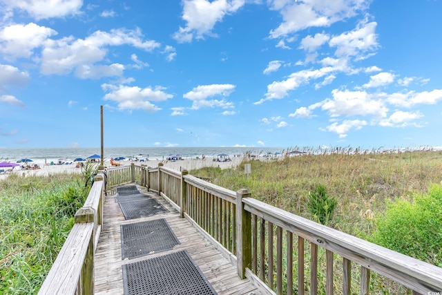 view of community with a water view and a view of the beach