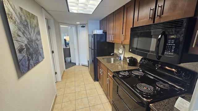 1105 S Ocean Blvd Unit 236, Myrtle Beach, SC 29577 - kitchen with black appliances, light tile patterned floors, dark stone countertops, and decorative backsplash
