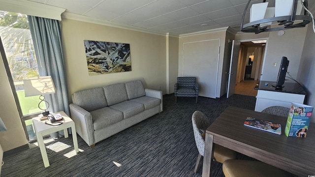 living room featuring crown molding and dark carpet