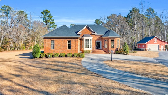 view of front of property with a garage and an outdoor structure