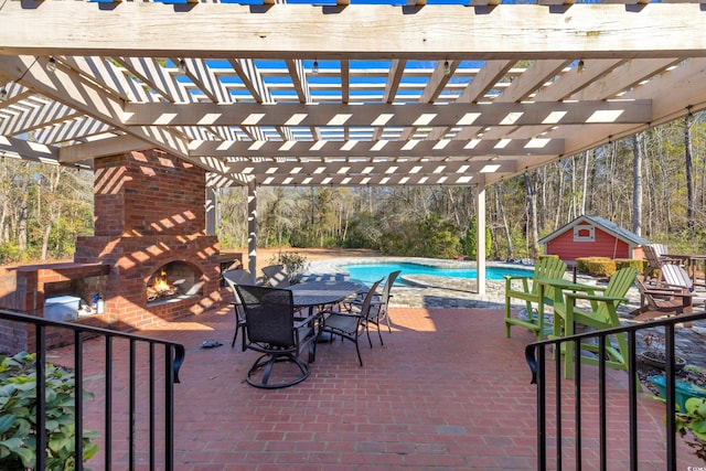 view of patio / terrace with an outdoor brick fireplace, an outbuilding, and a pergola