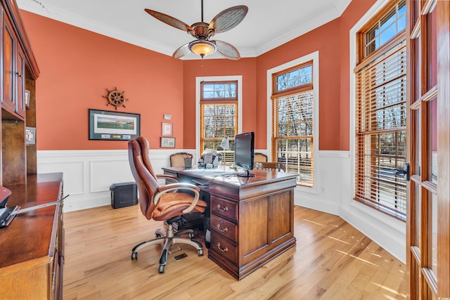 office space featuring ornamental molding, light hardwood / wood-style floors, and ceiling fan