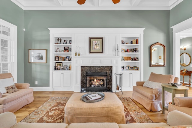 living room featuring ornamental molding, light hardwood / wood-style floors, and a premium fireplace