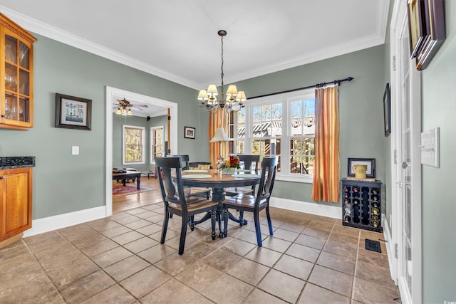 tiled dining area featuring crown molding and ceiling fan with notable chandelier